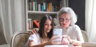 Photo of Woman Showing Her Cellphone to Her Grandmother