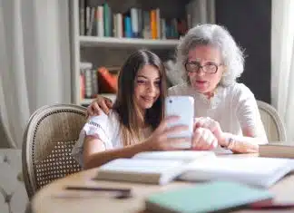 Photo of Woman Showing Her Cellphone to Her Grandmother