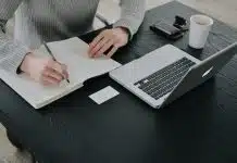 person in white dress shirt holding white paper